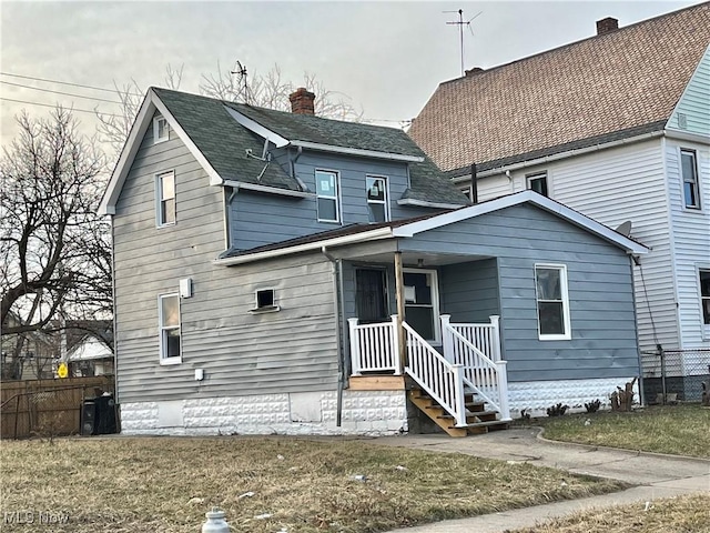 back of house with a yard and fence