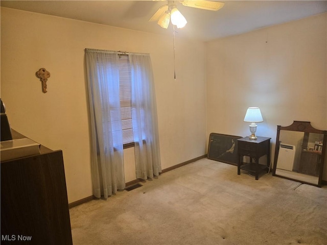 interior space featuring visible vents, baseboards, and a ceiling fan