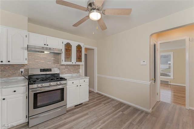 kitchen with white cabinets, stainless steel range with gas stovetop, and under cabinet range hood