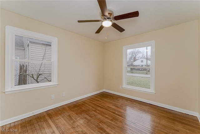 unfurnished room featuring wood-type flooring, baseboards, and ceiling fan