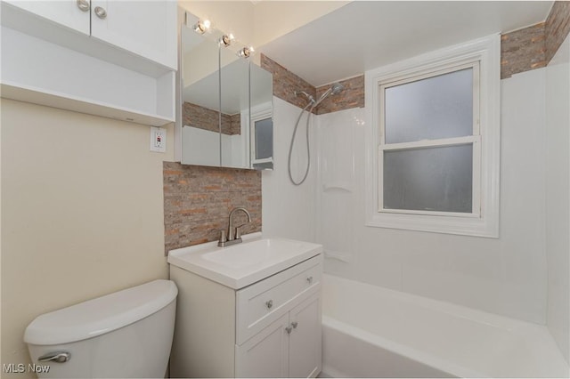 bathroom with shower / bathing tub combination, vanity, toilet, and decorative backsplash