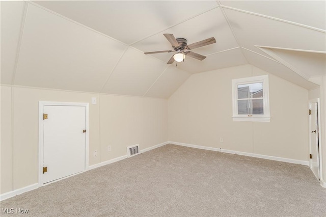 bonus room featuring baseboards, visible vents, a ceiling fan, carpet, and vaulted ceiling