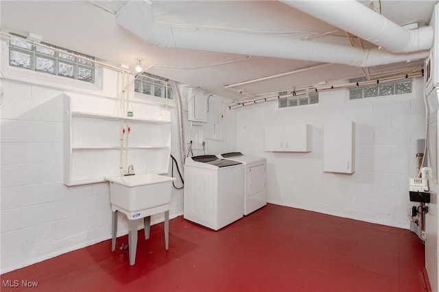 unfinished basement featuring washing machine and clothes dryer