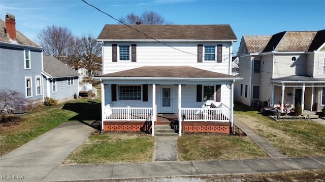 view of front of property with covered porch and a front lawn