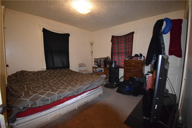 carpeted bedroom with a textured ceiling