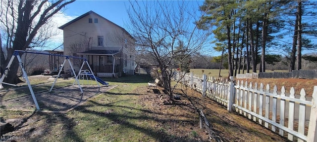 view of yard featuring a fenced backyard and a playground