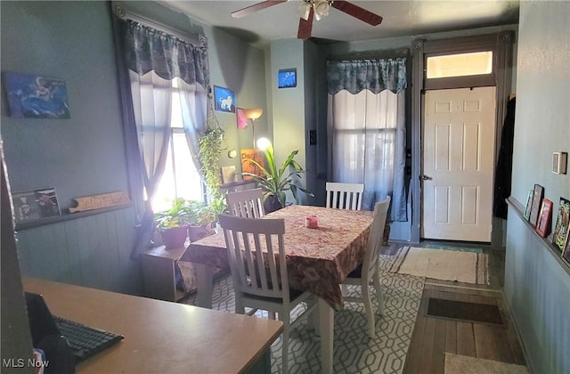 dining area with ceiling fan, baseboards, and wood finished floors