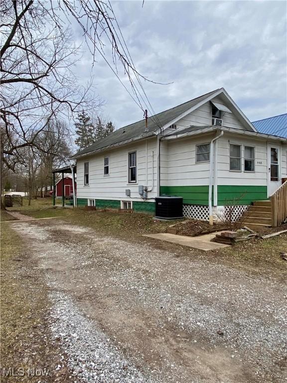 back of house featuring entry steps and central air condition unit