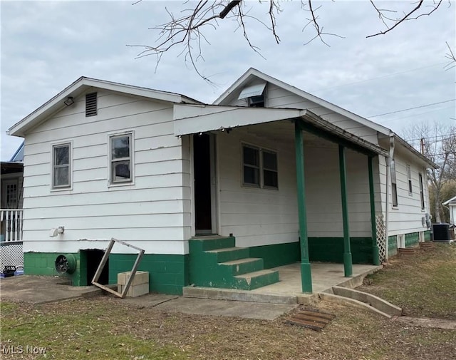 view of front of house with entry steps and central AC unit