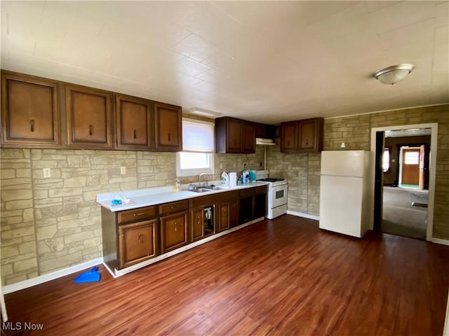 kitchen with dark wood-style flooring, light countertops, a sink, white appliances, and under cabinet range hood