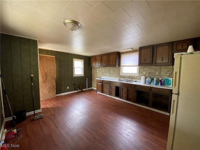 kitchen featuring plenty of natural light, dark wood finished floors, and freestanding refrigerator