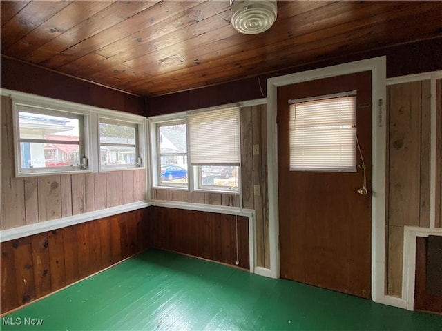 unfurnished sunroom with wood ceiling