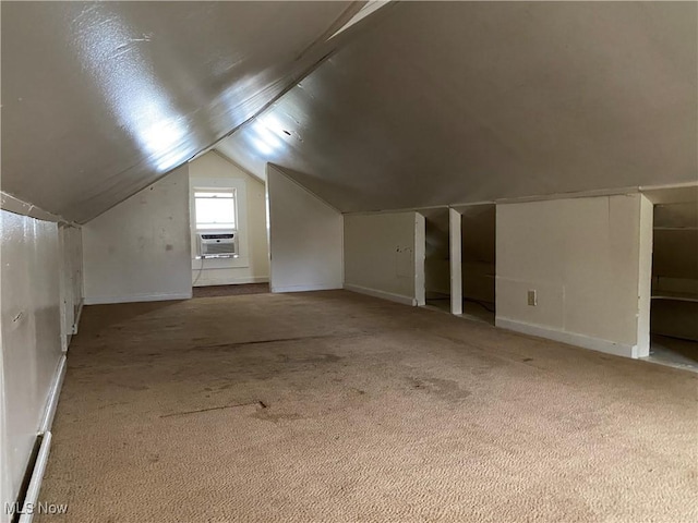 bonus room with cooling unit, carpet flooring, and vaulted ceiling