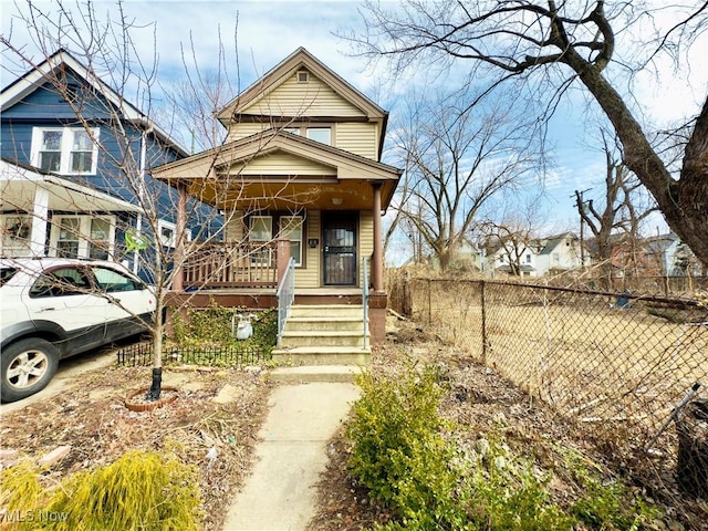 view of front facade featuring a porch and fence