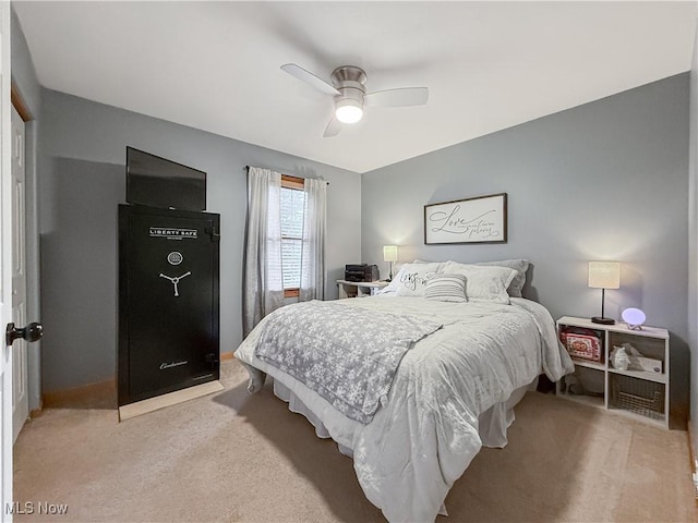 bedroom with ceiling fan and light carpet