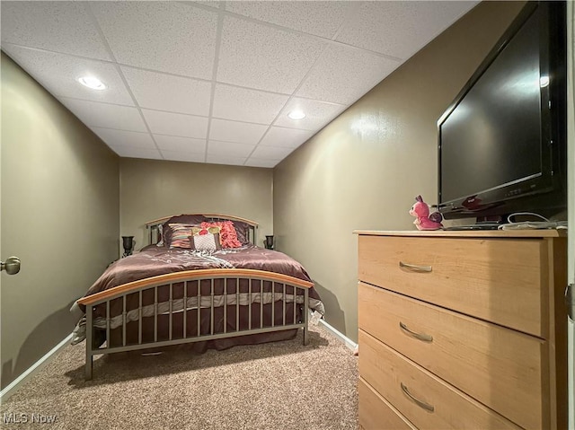 bedroom featuring carpet floors, a paneled ceiling, and baseboards