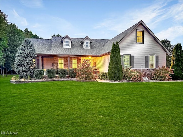 view of front of house featuring a front yard and roof with shingles