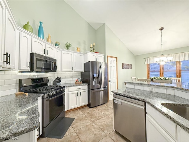 kitchen with hanging light fixtures, backsplash, an inviting chandelier, appliances with stainless steel finishes, and white cabinets