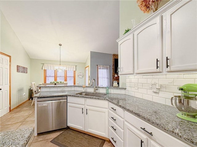 kitchen with decorative backsplash, white cabinets, dishwasher, a peninsula, and a sink