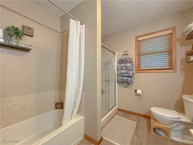 bathroom featuring baseboards, a shower with shower curtain, toilet, a bathing tub, and wood finished floors