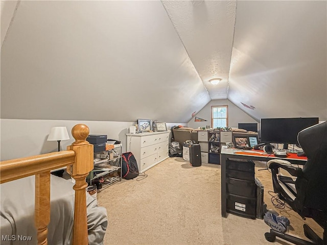 carpeted office space featuring vaulted ceiling