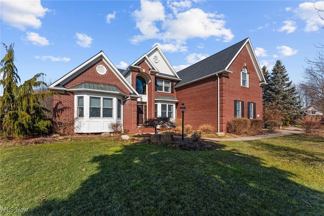 traditional-style house with brick siding and a front lawn