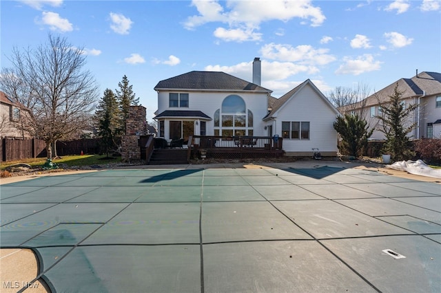 616 Coventry Pl, Amherst, OH 44001 - rear view of property featuring a fenced in pool, a chimney, a patio area, fence, and a wooden deck