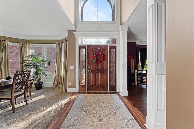 616 Coventry Pl, Amherst, OH 44001 - entrance foyer with wood finished floors, ornamental molding, and ornate columns