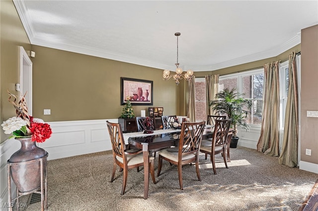 616 Coventry Pl, Amherst, OH 44001 - carpeted dining room featuring a chandelier, ornamental molding, and wainscoting