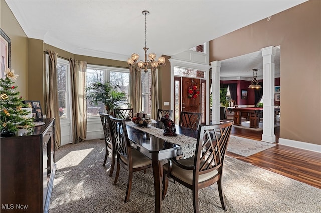 616 Coventry Pl, Amherst, OH 44001 - dining room featuring decorative columns, a chandelier, wood finished floors, and baseboards