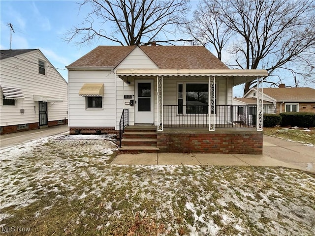 bungalow-style house featuring a porch and a shingled roof