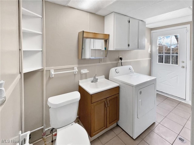 laundry room featuring washer / dryer, light tile patterned floors, and a sink