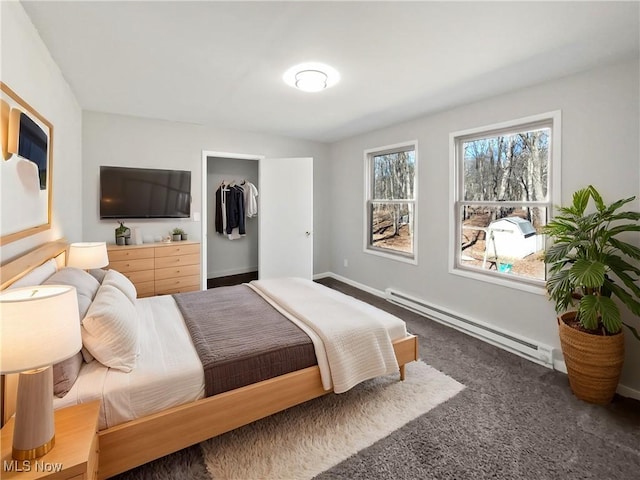 carpeted bedroom featuring baseboards and baseboard heating