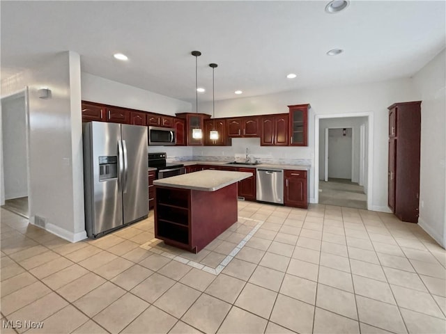 kitchen featuring light tile patterned floors, appliances with stainless steel finishes, light countertops, and a sink