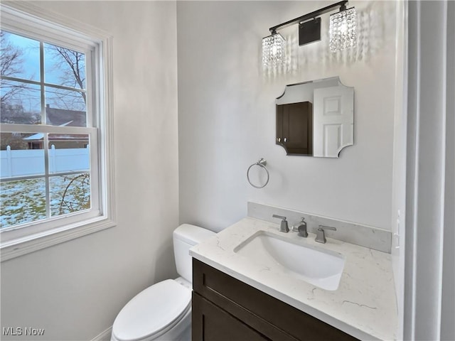 half bathroom with vanity and toilet