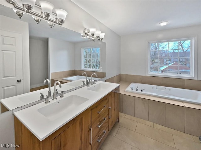 bathroom featuring tile patterned flooring, a sink, and a notable chandelier