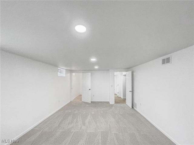 finished basement with recessed lighting, visible vents, baseboards, and light colored carpet