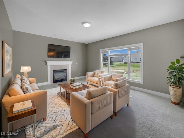 living room featuring light carpet, baseboards, and a tiled fireplace