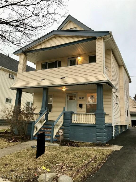 view of front facade with covered porch and a balcony