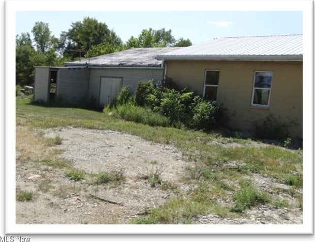 view of side of property with metal roof