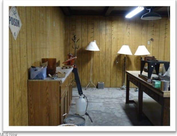 carpeted office with wooden walls