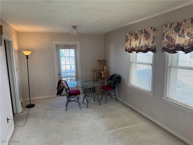 dining space with carpet and baseboards