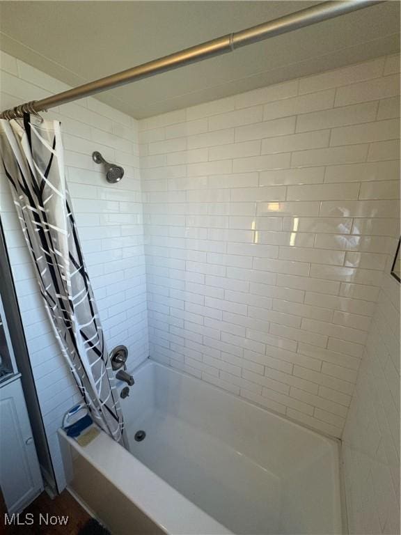 bathroom featuring shower / bathtub combination with curtain