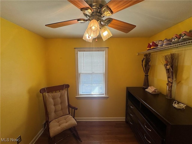 sitting room featuring dark wood-style floors, ceiling fan, and baseboards