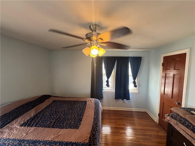 bedroom with baseboards, dark wood finished floors, and a ceiling fan