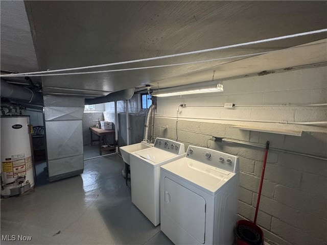 clothes washing area featuring laundry area, heating unit, washing machine and dryer, water heater, and a sink