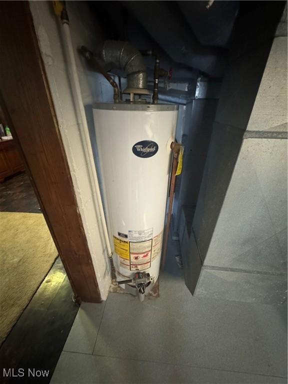 utility room featuring water heater