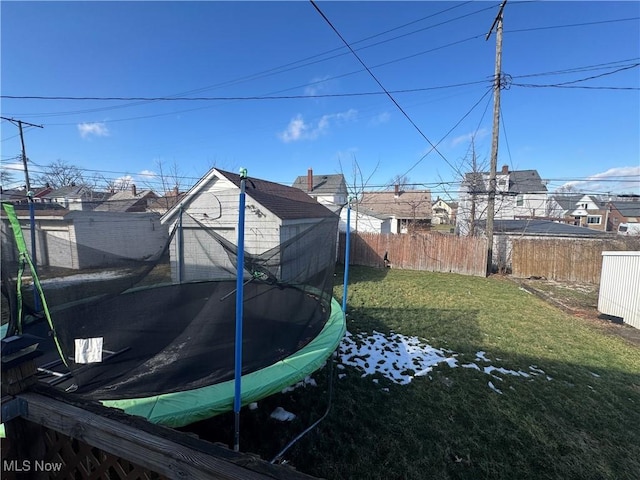 view of yard featuring a trampoline and a fenced backyard