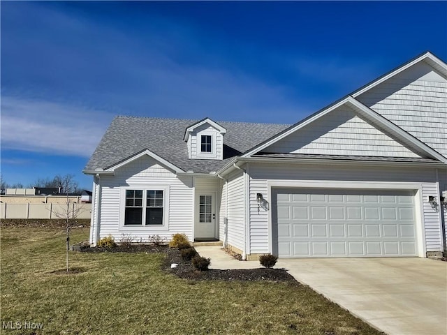 view of front of house with a garage, driveway, a shingled roof, and a front yard