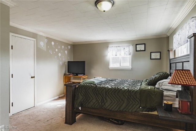 bedroom with carpet floors, ornamental molding, and baseboards